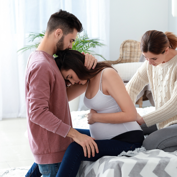 Pregnant couple with midwife at home